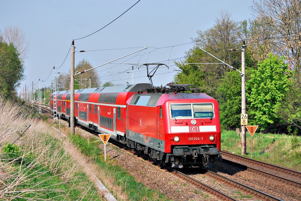 Ab nach Hamburch!!120 204 mit einem RE in die schon genannte Stadt,strebt ihrem nchsten Halt in Schwaan entgegen.Geknipst am 26.04.2011 in Sildemow.