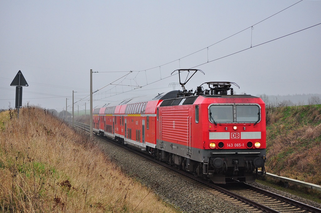 Mit im Werk Wittenberge umgebauten Dostos rollt die 143 065 am 06.12.2014 durch Gragetopshof in Richtung Rostock Hbf.