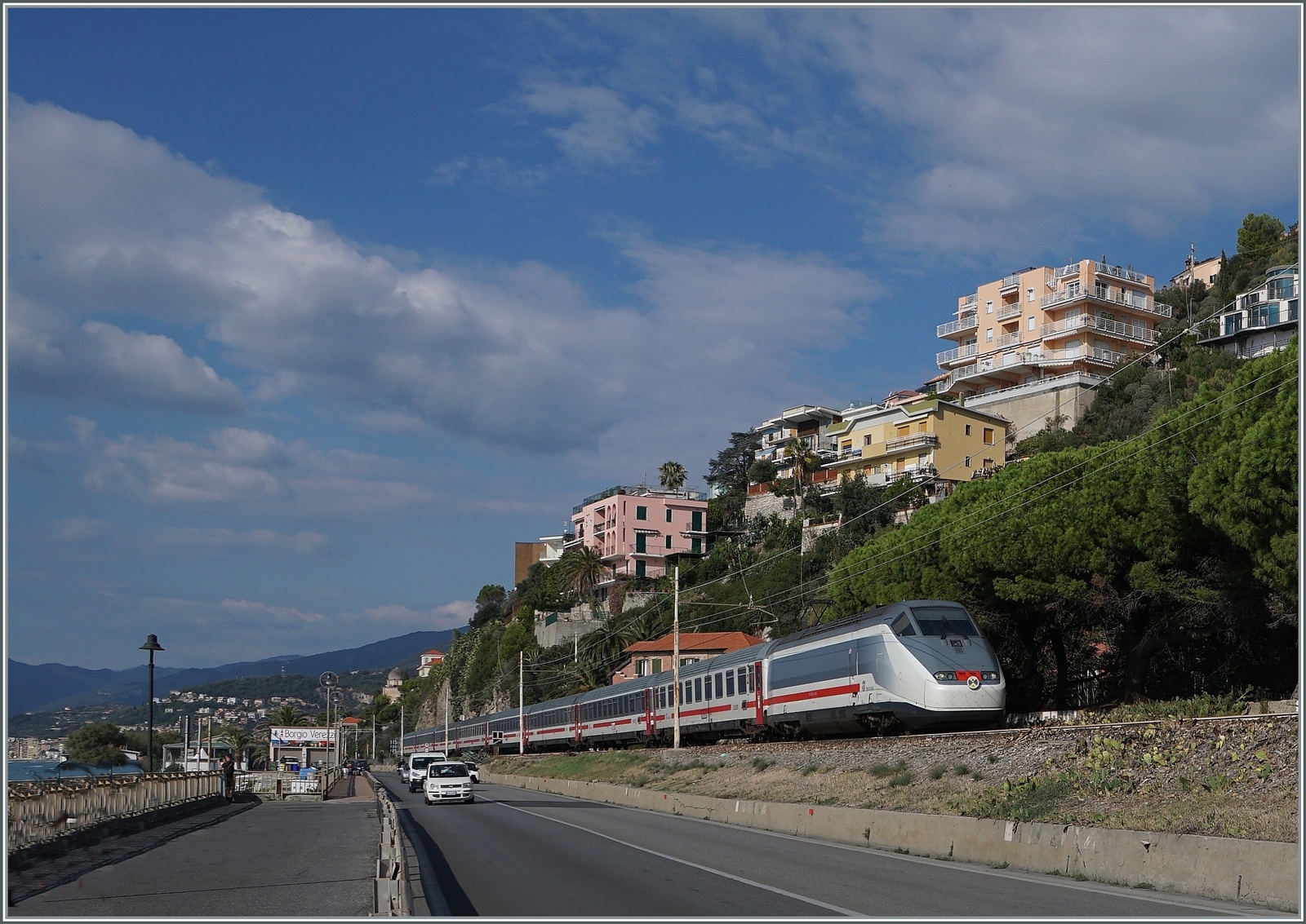 Mit zwei E 414 Triebköpfen bestückt fährt der IC 631 Ventimiglia nach Milano kurz vor Finale Liguere bei Borgio-Verezzi auf der hier noch einspurigen Strecke dem Meer entlang. 1872 wurde die Strecke eröffnet, doch der knappe Platz führte schon 1977 zu ersten Streckenverlegungen in Tunnels. Zur Zeit sind nur noch wenige Streckenabschnitte auf dem ursprünglichen Trassenverlauf in Betrieb. 

22. Sept. 2022