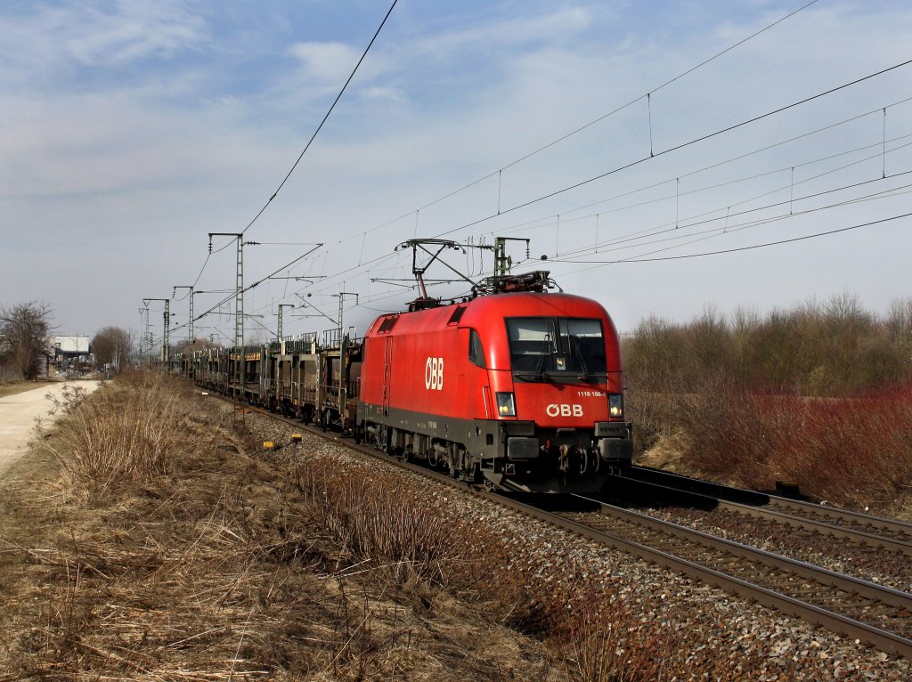 Die 1116 168 am 12.03.2011 mit einem Leeren Autozug unterwegs bei Obertraubling.