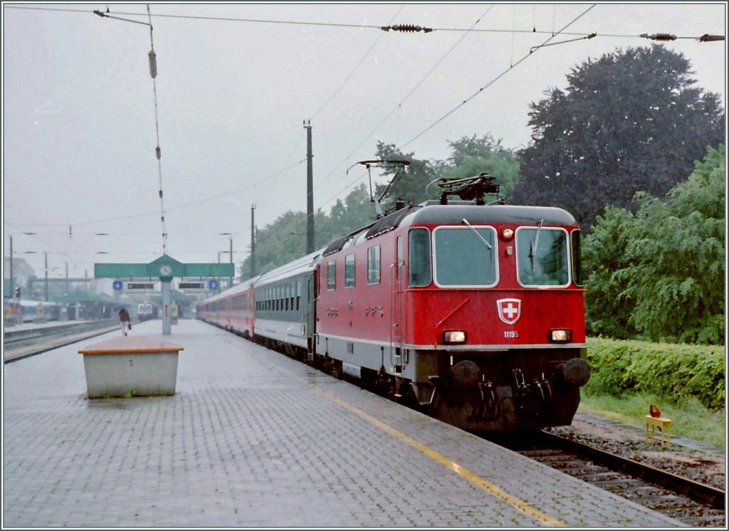 Die Re 4/4 II 11195 verlässt bei interessantem Fotowetter Bregenz Richtung Lindau. 
30. Mai 1995
