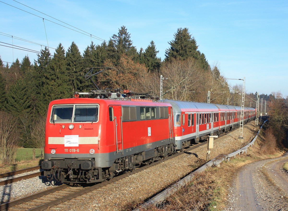 111 019-6 am 21. Dezember 2013 auf dem Weg nach Salzburg, zwischen Übersee und Bergen.