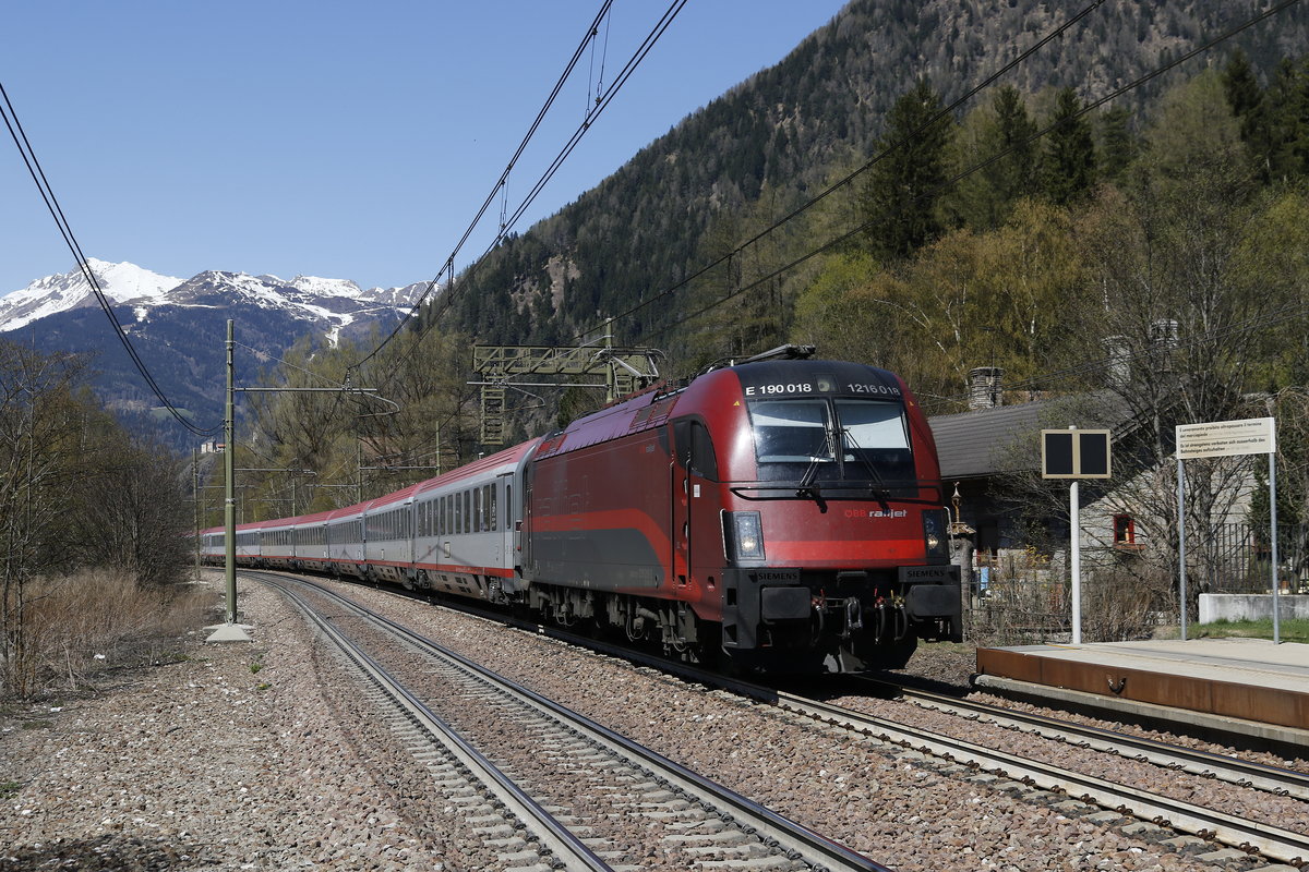 1216 018 mit dem Ec von Mnchen nach Verona. Aufgenommen bei der Einfahrt in den Bahnhof von  Freienfeld/Campo die Trens  in Sdtirol am 8. April 2017.