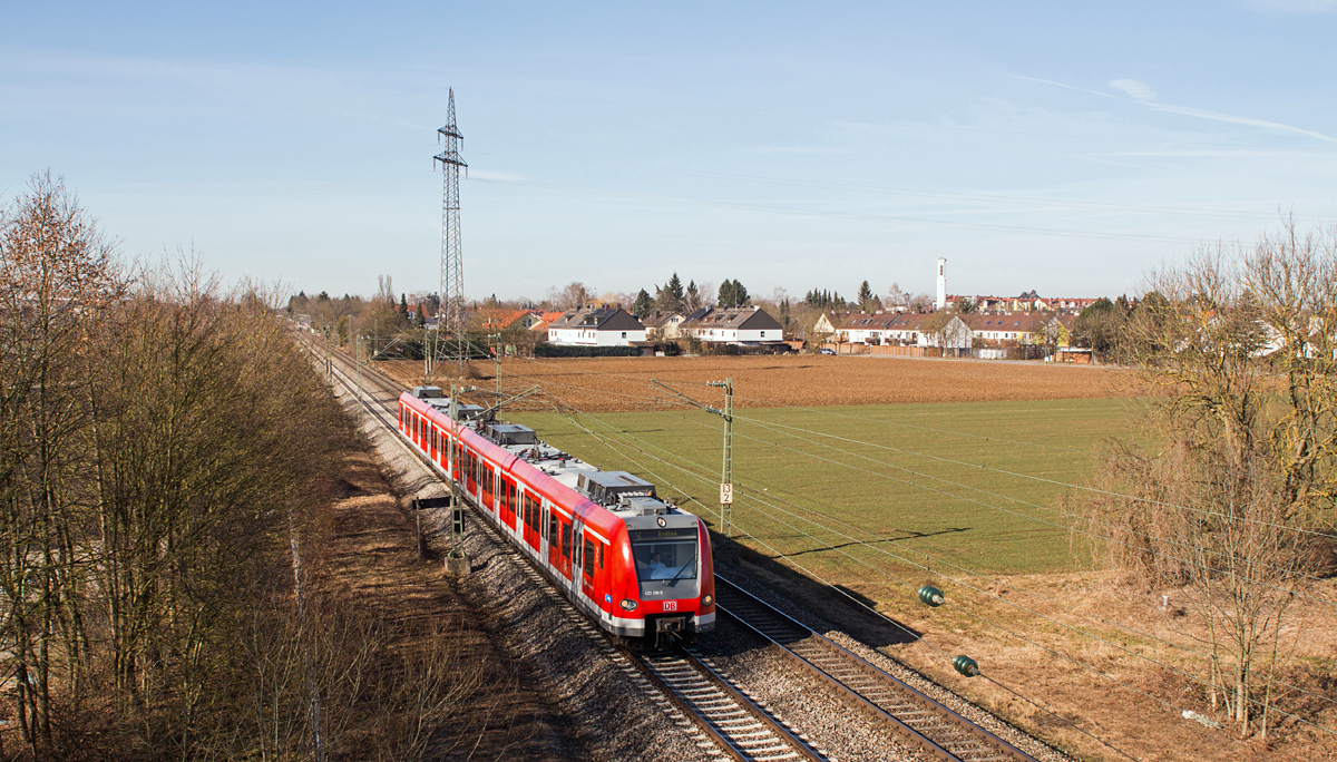 423 219-5 als S2 nach Erding läßt am Vormittag des 8. März 2015 die Ortschaft Heimstetten hinter sich.