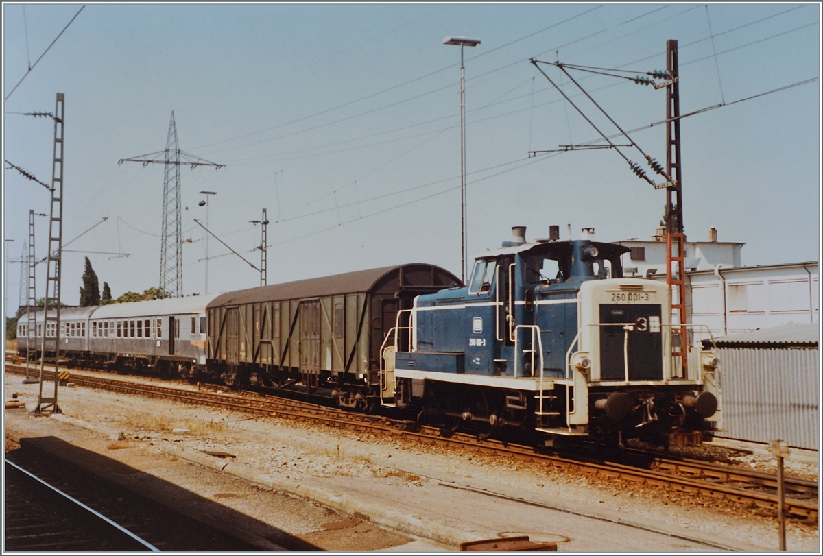 Die DB 260 001-3 rangiert in Basel Bad. Bf. eine Behelfsgepäckwagen und zwei  Silberlinge . 

Analogbild vom 30. Juli 1984