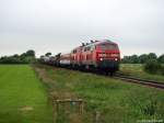 218 397-8 und 218 372-1 dieseln am 3.7.11 mit dem AS 1424 nach Westerland (Sylt) kurz hinter Niebll durch die Landschaft.