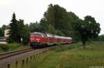 218 329-1 jagt am 19.6.12 mit dem RE nach Kiel Hbf. bei Behl durch die Landschaft.