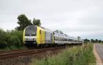 Mit der NOB 81722 nach Westerland (Sylt) am Haken rollt ER 20-011 am 4.7.11 kurz vor Niebll durch die Landschaft.