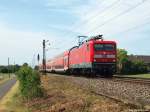 112 166-4 fhrt am 4.6.11 mit dem RE 11 nach Hamm (Westf) bei Nordbgge durch die Landschaft.
