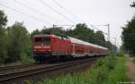 112 180-5 rauscht am 31.7.11 mit dem RE 21019 nach Hamburg Hbf. durch den Prisdorfer Wald.
