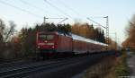 112 143-3 fhrt am 21.12.11 mit dem RE nach Hamburg Hbf. durch den Ort Prisdorf.
