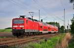 Mit der S2 aus Gstrow rollt die 143 564 am 24.05.2013 durch Sildemow in Richtung Rostock Hbf.