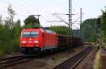 DB 6185 203-7 hat den RBH Holzzug aus Padborg/DK geholt und stebt nun gen Hamburg hier durch Schleswig. 28.07.2014
